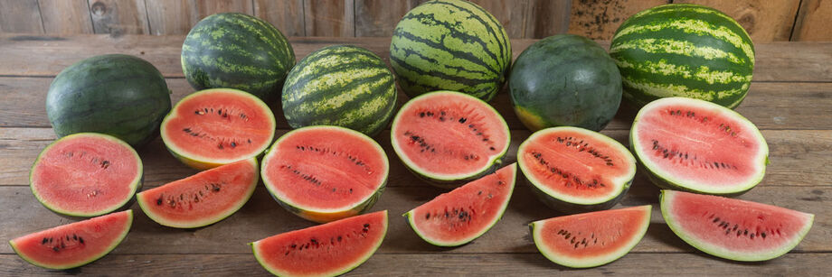 Six watermelons shown cut open with bright pink interiors.