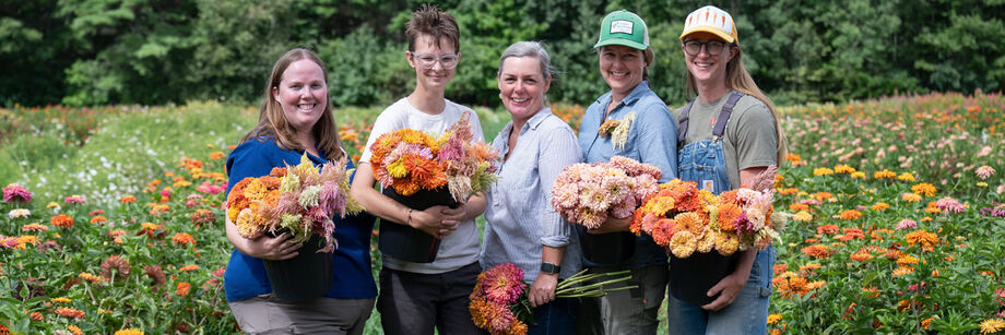 Johnny's Flower Breeding Team standing in a field of Johnny's-bred zinnias.
