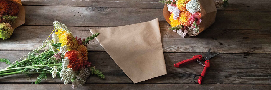 Flower bouquets in plastic sleeves.