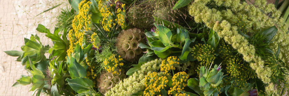 A bouquet of green and green-tinted flowers and flower fillers.