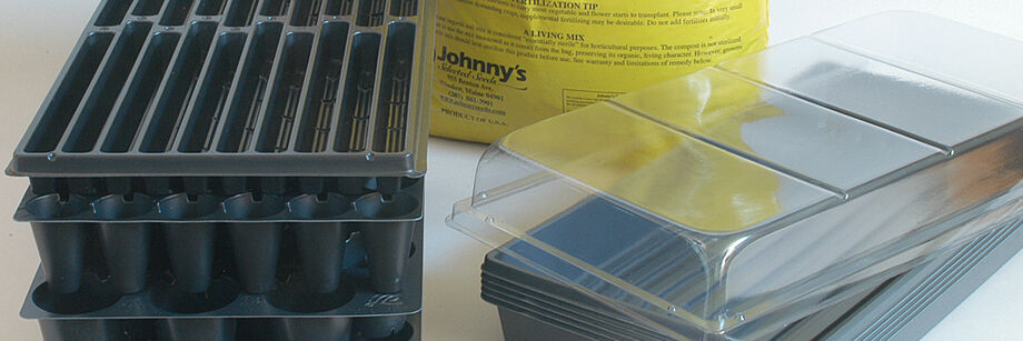 A seed starter kit including trays, flats, a humidity dome, and seed starting mix.