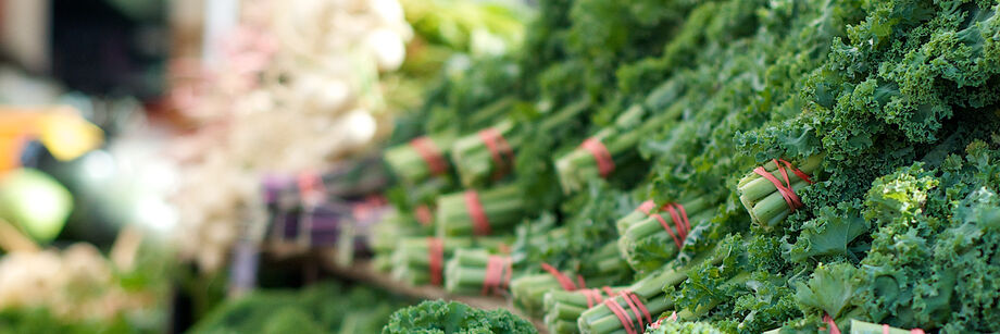 Bunches of kale for sale at a market.
