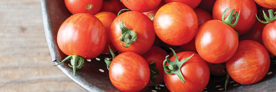 Striped red cherry tomatoes in bowl.
