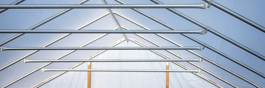 View from inside one of our high tunnel kits; visible are the roof purlins and plastic sheeting.