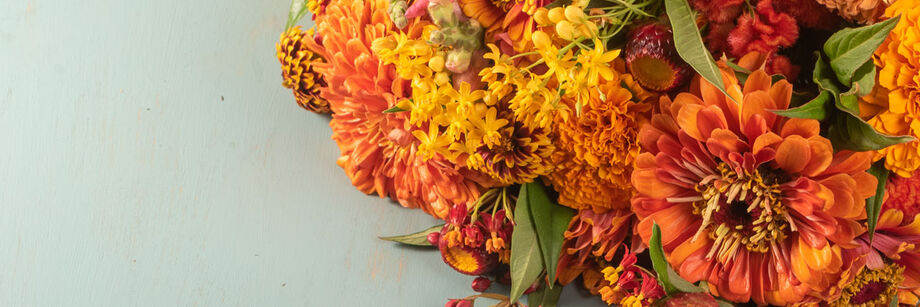 Bouquet of flowers in orange, coral, and pink.