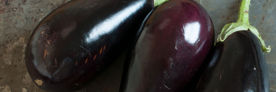 Three deep purple Italian eggplants.