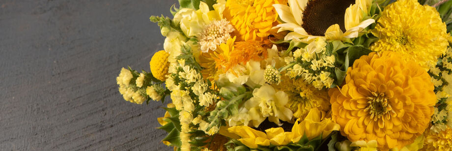 A bouquet of yellow and gold colored cut flowers.