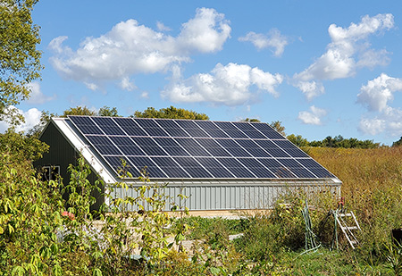 Solar-panel-topped shed at Joy de Fleur Farm, St. Paul, Minnesota