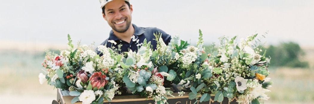 Julio Freitas, shown here with a large floral arrangement, is a contributor to our article, Pricing and Profitability for Today's Flower Farmer