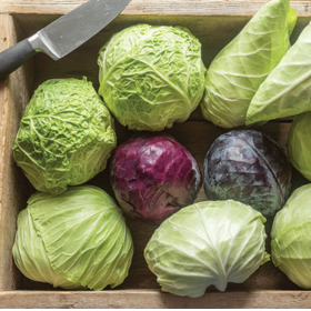 several types of cabbage in a wood box