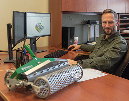 Brad Waugh, Johnny's Mechanical Product Design & Outsourcing Engineer, at his desk