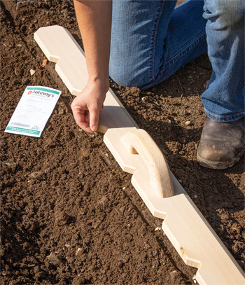 A notched cedar planting Board is especially useful in small spaces where it's easiest to hand-sow your seeds.