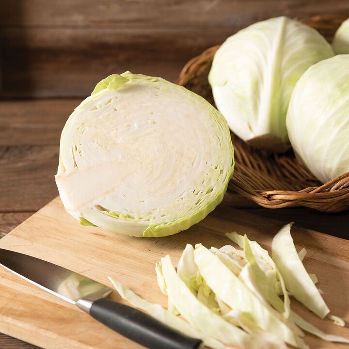 head of cabbage cut open on cutting board