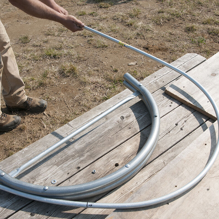 man bending tunnel frames