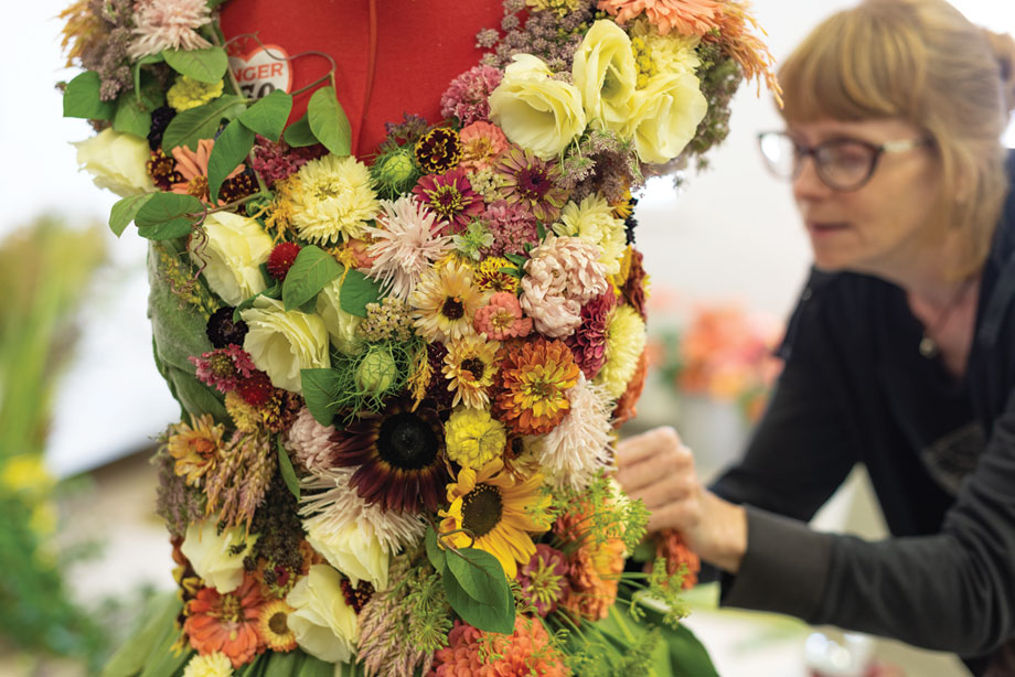 Floral Designer Rayne Grace Hoke at work on the gown