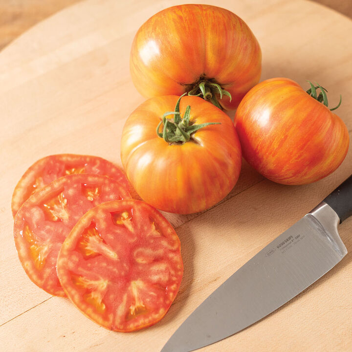 Tomatoes sliced on cutting board